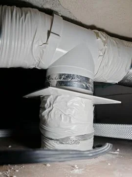 Taped connection on an installed metal ventilation duct, overhead view Stock Photos