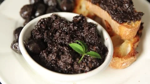 Tapenade black olives olive spread ready to eat tasty snack fresh gourmet food Stock Footage 336678477