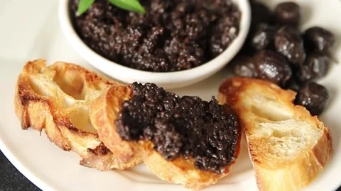 Tapenade black olives olive spread ready to eat tasty snack fresh gourmet food Stock Footage 336678478