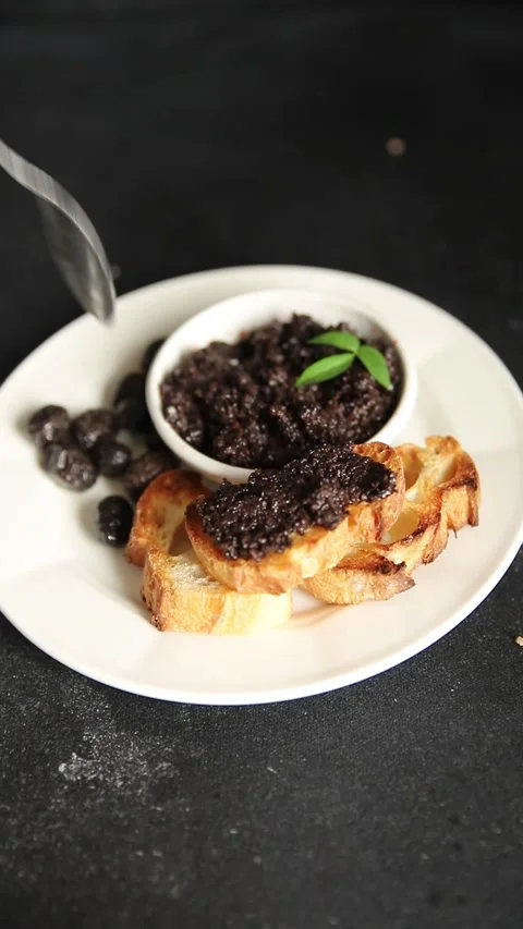 Tapenade black olives olive spread ready to eat tasty snack fresh gourmet food Stock Footage 336678480