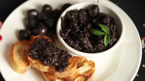 Tapenade black olives olive spread ready to eat tasty snack fresh gourmet food Stock Footage 336678489