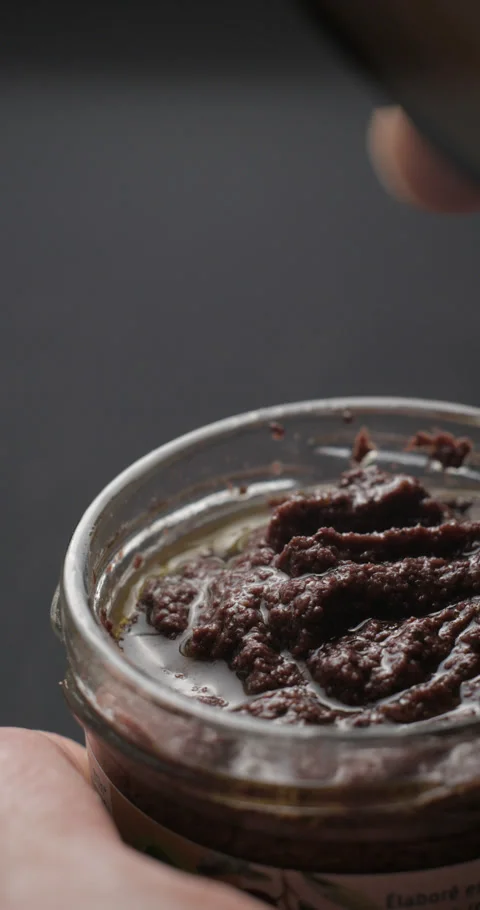 Tapenade bottle opening slow motion, vertical view Stock Footage 280523247