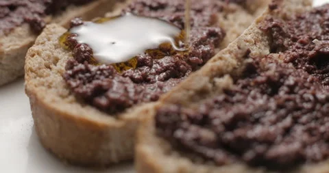Tapenade olive puree on bread rotating close-up studio Stock Footage 280522934