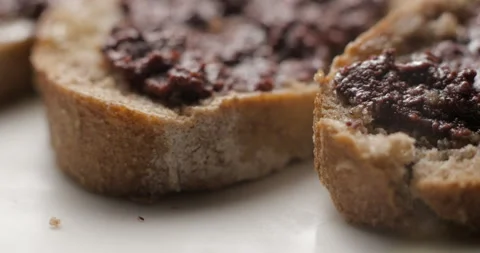 Tapenade olive puree on bread rotating close-up studio Stock-Footage 280522953