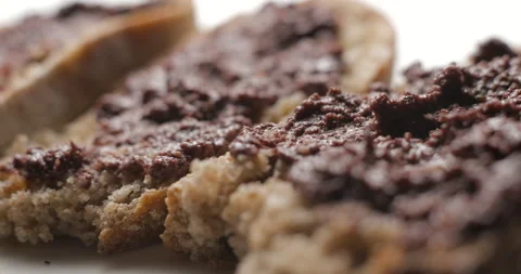 Tapenade olive puree on bread rotating close-up studio Stock-Footage 280523089