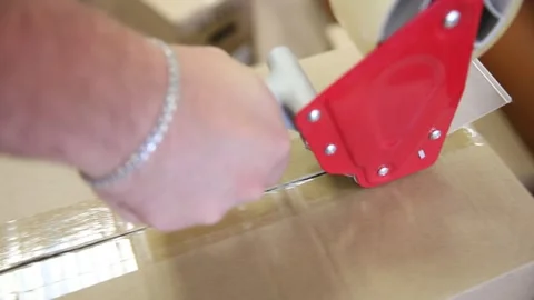 Taping large boxes. using a manual device Stock Footage 304688930