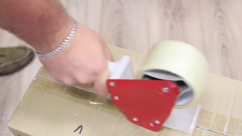 Taping large boxes. using a manual device Stock Footage 304688938