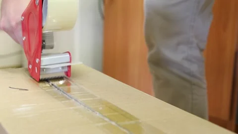 Taping large boxes. using a manual device Stock Footage 304688941