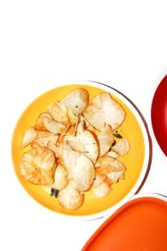 Tapioca chips / Cassava chips in white bowl on a white background .Kerala sty Stock Photos