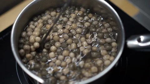 Tapioca preparation process, organic tapioca bubbles in boiling water, boba tea Stock Footage 129430303