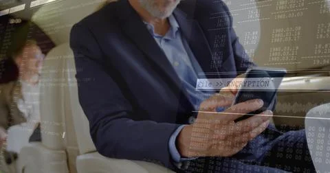 Tapping bearded executive man in suit using tablet in aircraft cabin, with Stockfoto's