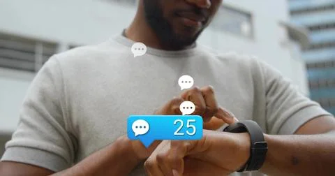 Tapping black smartwatch, man in light grey T-shirt checking chat bubbles Stock Photos