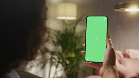 Tapping on Center Screen. Back View of Woman at Living Room Sitting on a Chair Stock Footage 205849453