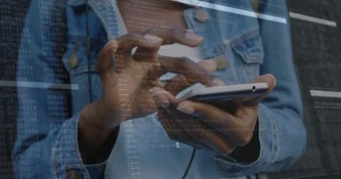 Tapping developer hands in denim jacket on phone touchscreen at tech workspace, 写真素材