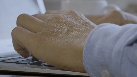 Tapping laptop close up. Man hands typing on the keyboard. Working from home  Stock Footage 128116434