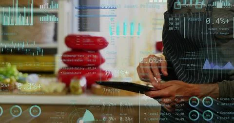 Tapping man in apron using tablet in kitchen, red bowls, produce, data overlays, Stock Photos