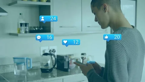Tapping man in grey sweater using smartphone at kitchen counter with blue Stock Footage 332882045