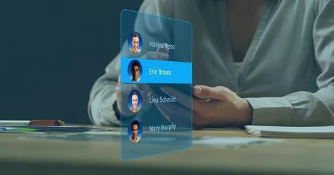 Tapping man wearing light button-up shirt using holographic contacts at desk, Stock Photos