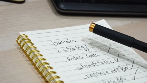 Tapping Pen On Business AI Strategy Notebook Stock Footage 340849238