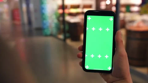 Tapping the screen of your smartphone. A phone in front of a shopping mall. Stock Footage 169517639