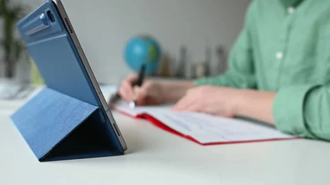 Tapping tablet closeup during online course Video stock 168513534