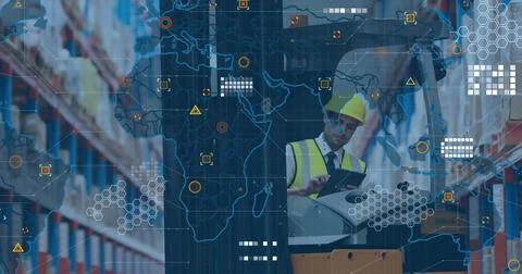 Tapping tablet, manager in yellow hard hat and vest at depot monitoring pallet Stock Photos