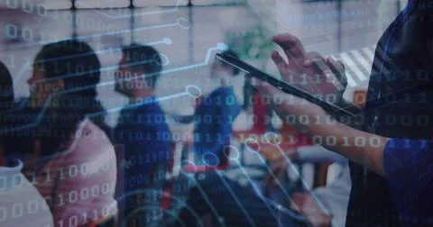 Tapping tablet, trainer in navy long-sleeve guiding session in glass room, data Stock Photos