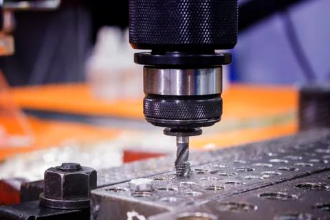 Tapping tool in spindle tapping into a hole in steel plate Stock Photos