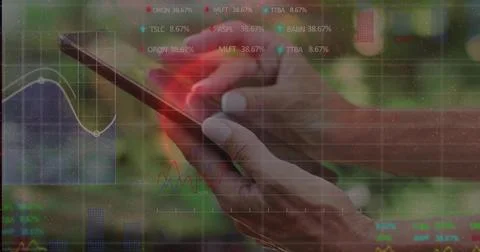 Tapping touchscreen device with mature woman's hands at desk, showing trading Stock Photos