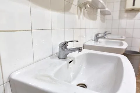 Taps an basins in a row Stock Photos