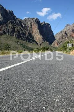 Tar or Ashphalt Road and Mountains Stock Photos