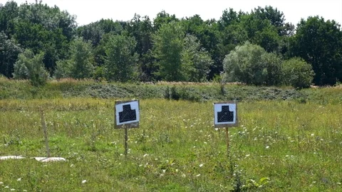 Target for firing at the range. Shooting Range Gun Target With Bullet Holes Stock Footage 118374323