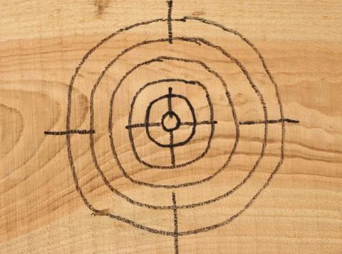 Target on wooden background. Stock Photos