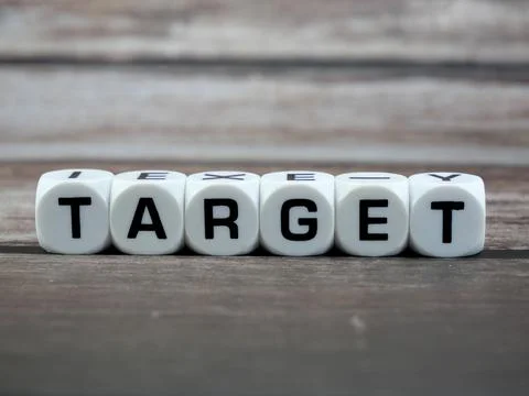 Target wording  or text on white dice with black wooden background.Copy spa.. Stock Photos