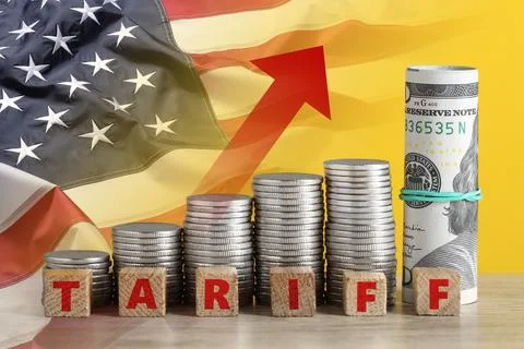 Tariff increase. Stacks of coins, cubes, dollar bills on table and flag of US Stock Photos