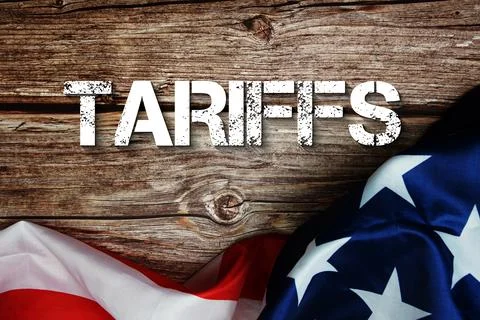 Tariffs text message with USA flag on wooden background Stock Photos