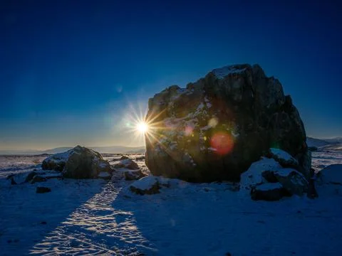 Tarkhatinsky megalithic complex at sunny winter day. Chui steppe and blue m.. Stock Photos