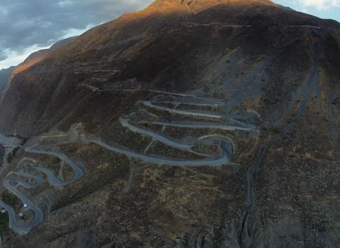 Tarmac road with switchbacks snaking up a steep mountain in Peru. Stock Photos