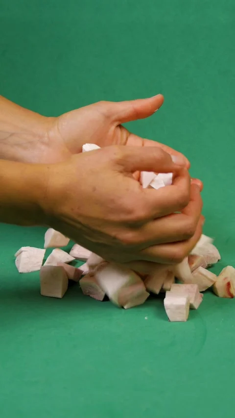 Taro cubes falling on green background Stock Footage 270183606