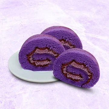 Taro flavored olled sponge cake on a white plate Stock Photos