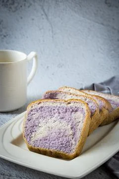 Taro flavour soft bread in white plate Stock Photos