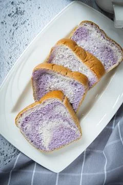Taro flavour soft bread in white plate Stock Photos