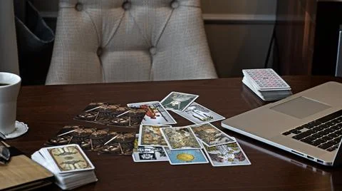 Tarot card reader arranges cards in a card spread. Fortune-telling concept Stock Photos