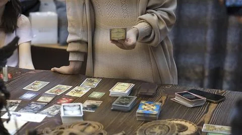 Tarot card reader arranges cards in a card spread. Fortune-telling concept Stock Photos