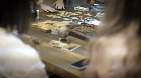 Tarot card reader arranges cards in a card spread. Fortune-telling concept Stock Photos