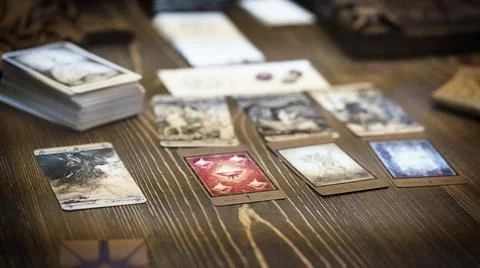Tarot card reader arranges cards in a card spread. Fortune-telling concept Stock Photos