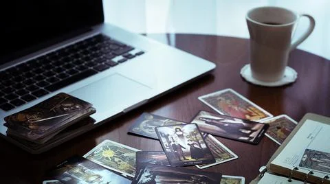 Tarot card reader arranges cards in a card spread. Fortune-telling concept Stock Photos