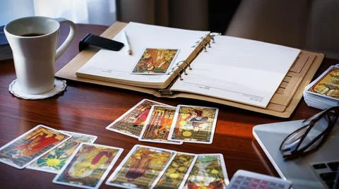 Tarot card reader arranges cards in a card spread. Fortune-telling concept Stock Photos