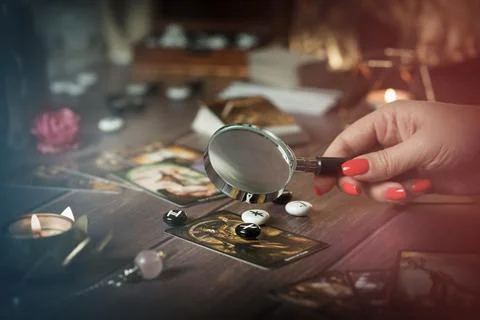 Tarot card reader arranges cards in a card spread. Fortune-telling concept Stock Photos