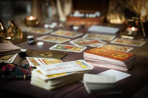 Tarot card reader arranges cards in a card spread. Fortune-telling concept Stock Photos